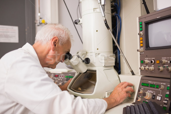 Biochemist using large microscope and computer Stock photo © wavebreak_media