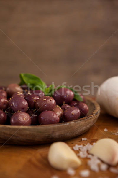 Close up of black olives by garlic on cutting board Stock photo © wavebreak_media