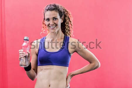 Smiling woman with bottle of water posing  Stock photo © wavebreak_media