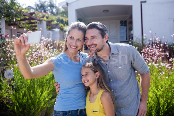 Parents and daughter taking a selfie on mobile phone Stock photo © wavebreak_media