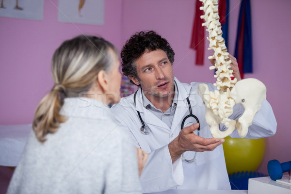 Physiotherapist explaining the spine model to patient Stock photo © wavebreak_media