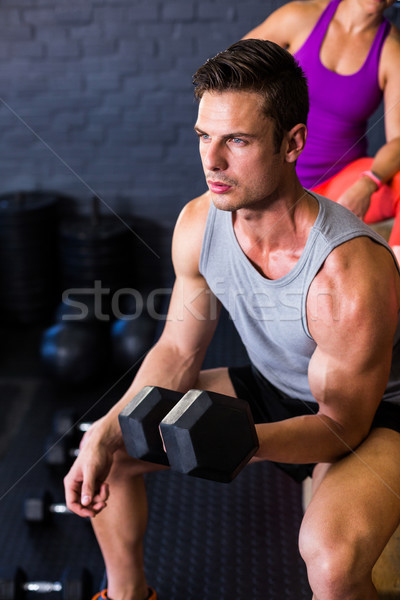 Stock photo: Male athlete exercising with dumbbell 