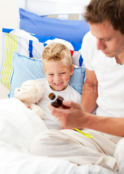 Caring man looking after his sick son Stock photo © wavebreak_media