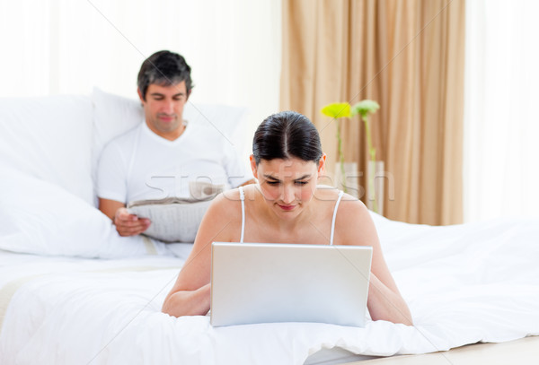 Stock photo: Couple relaxing on their bed