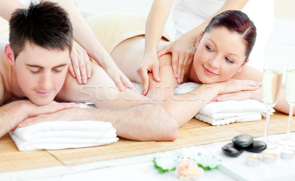 Stock photo: Loving young couple enjoying a back massage in a spa center