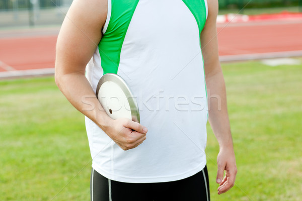 Close-up of a male athlete holding a discus in a stadium Stock photo © wavebreak_media