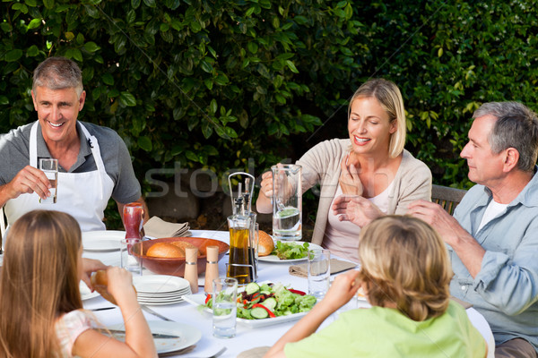 Stock photo: Lovely family eating in the garden