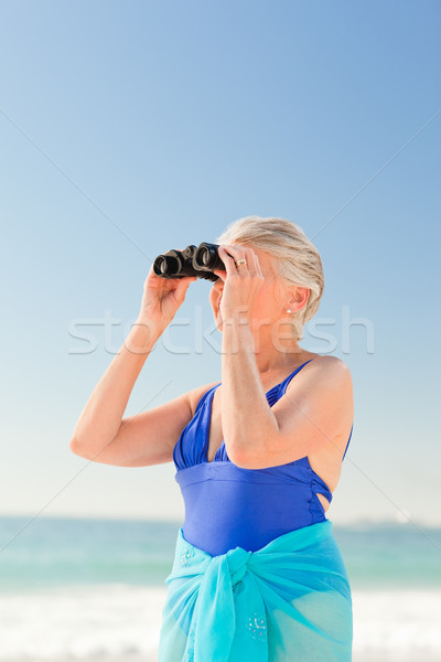 Senior woman bird watching at the beach Stock photo © wavebreak_media