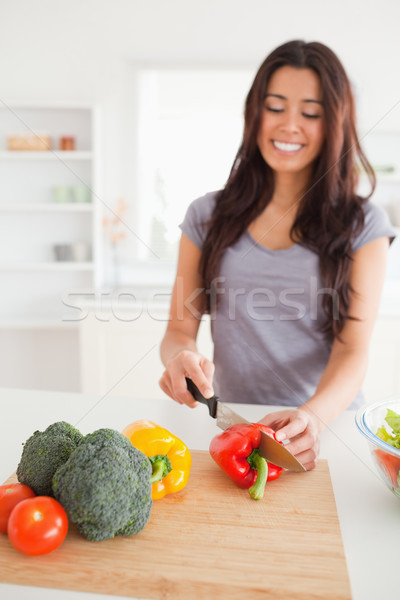 Stock photo: Charming female cooking vegetables while standing in the kitchen