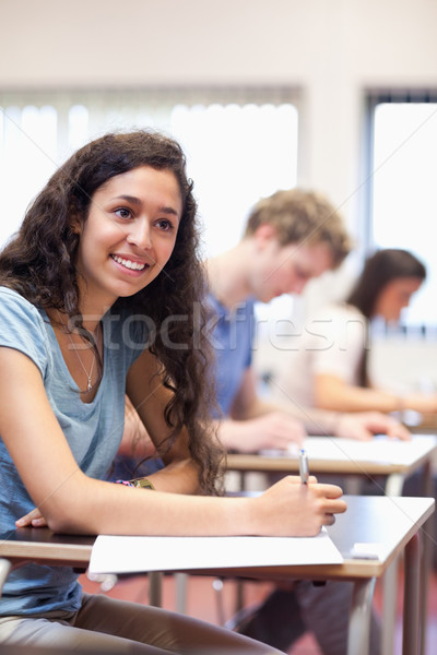 Portrait of happy young adults writing in a classroom Stock photo © wavebreak_media
