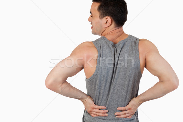 Man having a back pain against a white background Stock photo © wavebreak_media