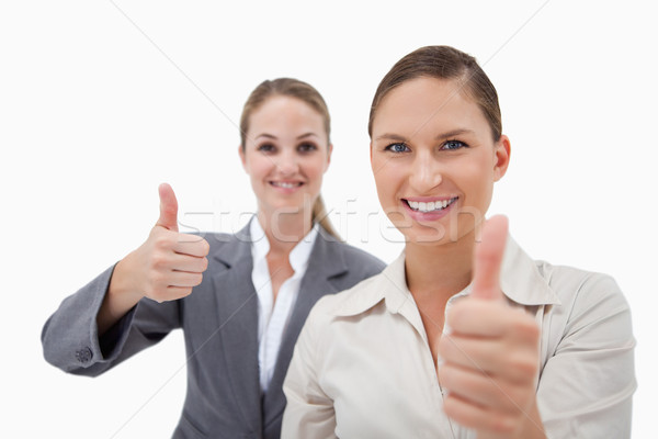 Sales persons posing with the thumb up against a white background Stock photo © wavebreak_media