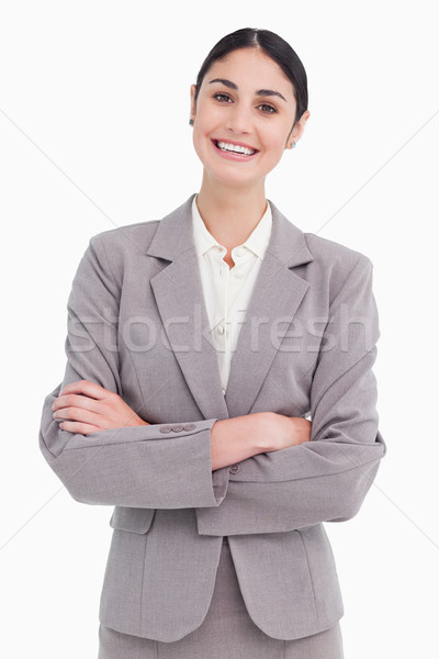 Smiling young saleswoman with arms crossed against a white background Stock photo © wavebreak_media
