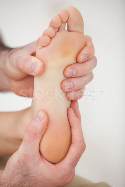 Physiotherapist working on a barefoot in a room Stock photo © wavebreak_media