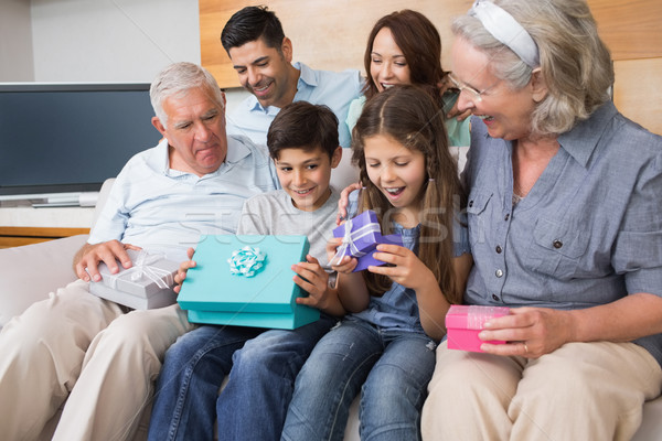 Extended family sitting on sofa with gift boxes in living room Stock photo © wavebreak_media