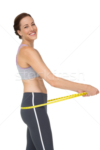 Portrait of a fit woman measuring buttocks Stock photo © wavebreak_media
