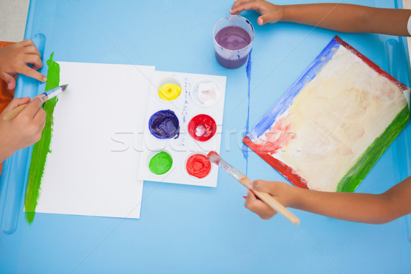 Cute little boys painting at table in classroom Stock photo © wavebreak_media