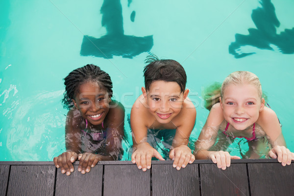 Cute swimming class in pool with coach Stock photo © wavebreak_media