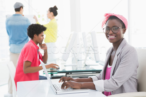 Young creative woman using laptop at desk Stock photo © wavebreak_media