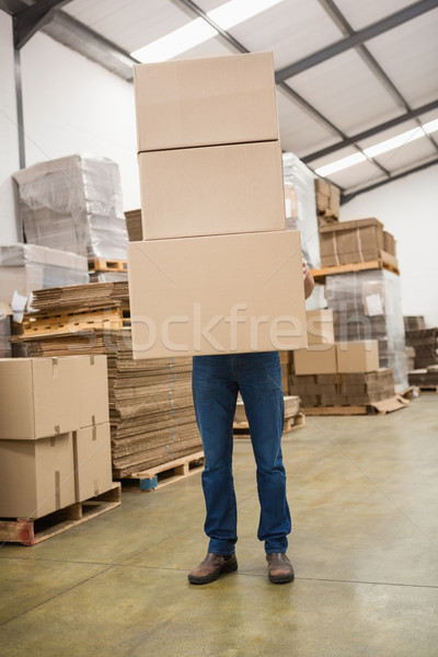 Worker carrying boxes in warehouse Stock photo © wavebreak_media