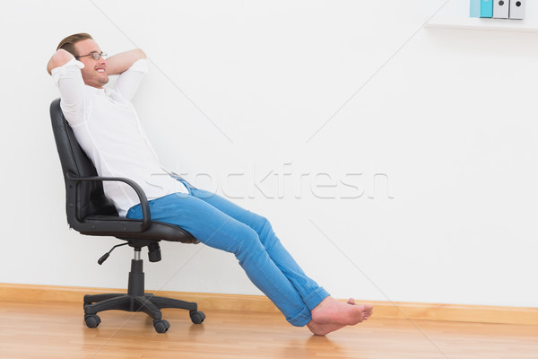 A man leaning back in swivel chair at home  Stock photo © wavebreak_media