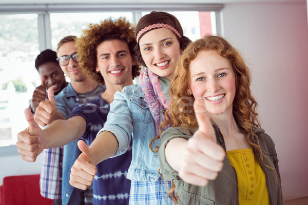 Students smiling in a single line with thumbs up Stock photo © wavebreak_media