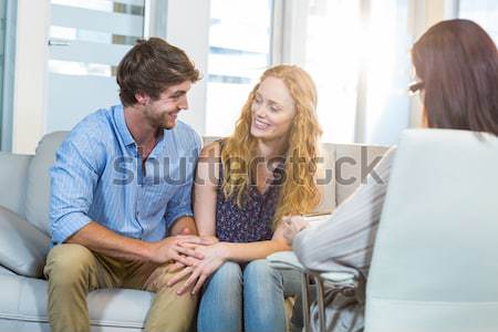 Stock photo: Couple doing their accounts sat in a couch
