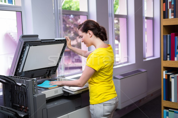 Student photocopying her book in the library  Stock photo © wavebreak_media