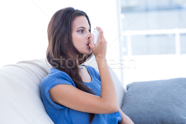Beautiful brunette using inhaler  Stock photo © wavebreak_media