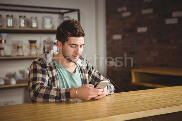 Smiling hipster sitting and texting Stock photo © wavebreak_media