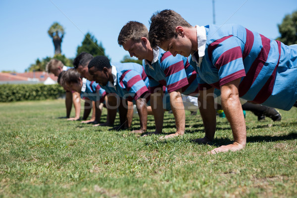 Close up of players doing push up at grassy field Stock photo © wavebreak_media