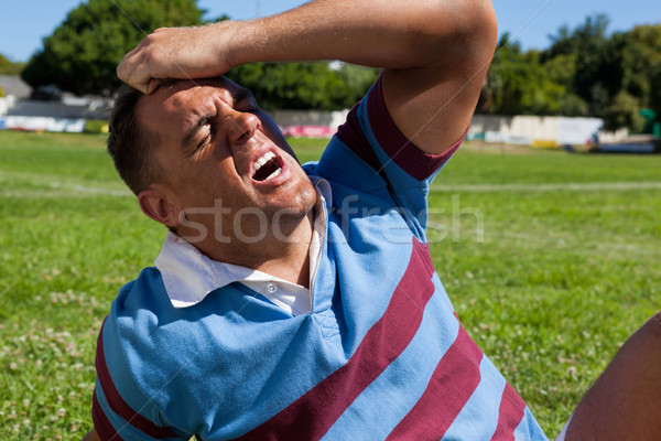 Unhappy rugby player sitting on field Stock photo © wavebreak_media