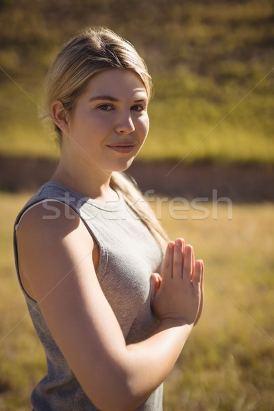 Portrait of beautiful woman praising yoga during obstacle course Stock photo © wavebreak_media