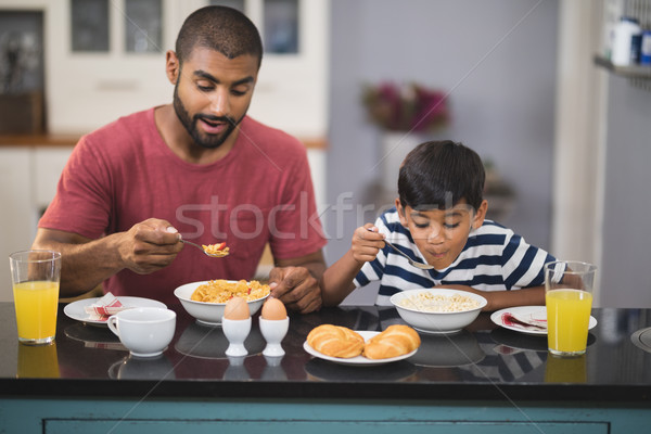 Man with his son having breakfast in kitchen Stock photo © wavebreak_media