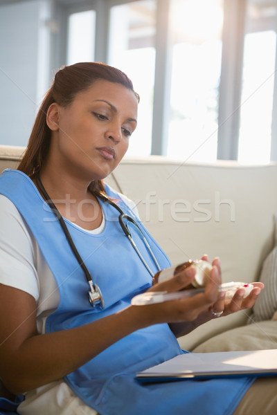 Doctor examining prescription pill bottle Stock photo © wavebreak_media