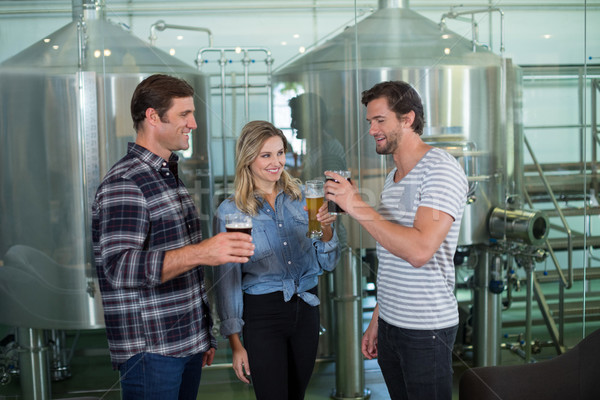 Stock photo: Friends tasting beer