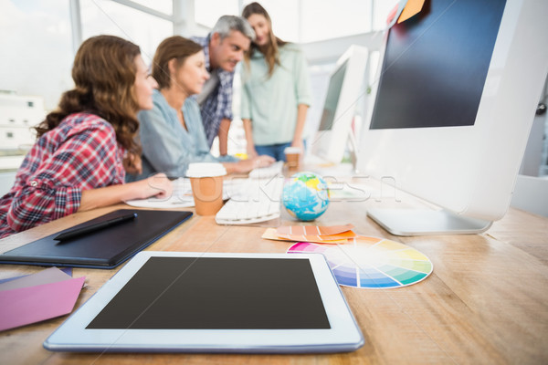 Tablet in the foreground with business people in the background  Stock photo © wavebreak_media