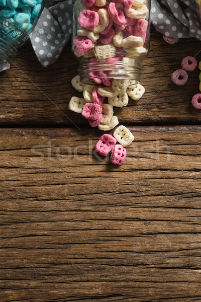 Scattered cereals from jar on wooden table Stock photo © wavebreak_media