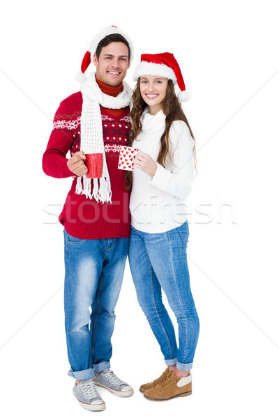 Happy couple with santa hats holding mug Stock photo © wavebreak_media