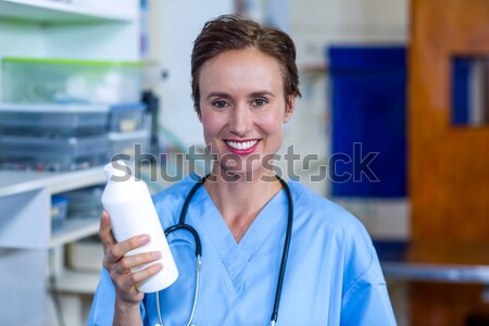Portrait of woman vet smiling and having a stethoscope on her ea Stock photo © wavebreak_media