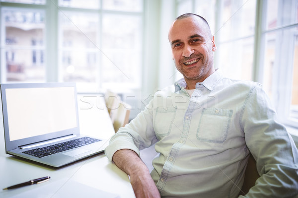 Mosolyog üzletember ül laptop portré kreatív Stock fotó © wavebreak_media