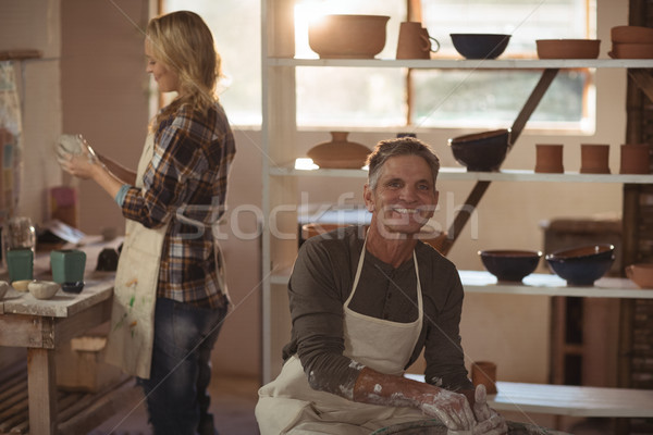 Smiling male potter making pot in pottery workshop Stock photo © wavebreak_media