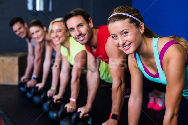 Smiling athletes exercising with kettlebells Stock photo © wavebreak_media