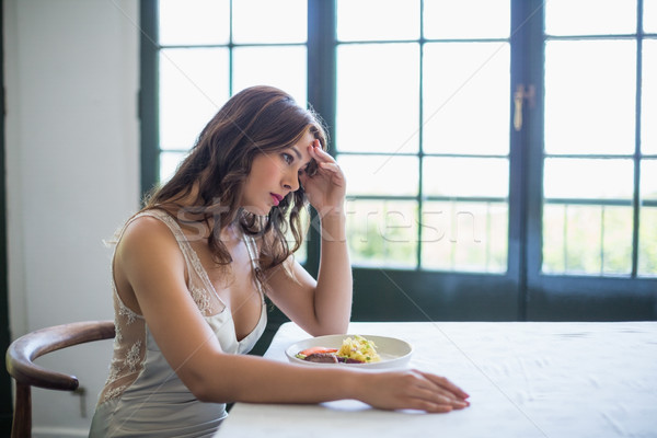 Stock photo: Depressed woman sitting