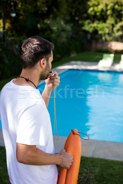 Lifeguard blowing whistle at poolside Stock photo © wavebreak_media