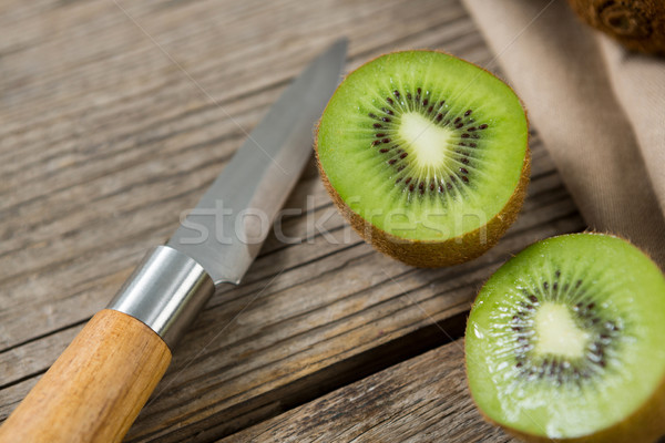 Kiwis with knife on wooden table Stock photo © wavebreak_media