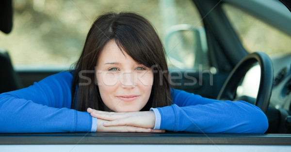 Cute teen girl smiling at the camera sitting in her car Stock photo © wavebreak_media