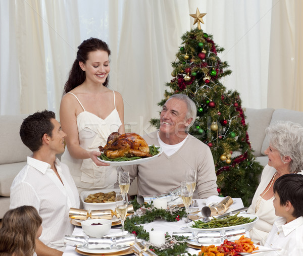 Woman showing turkey to her family for Christmas Stock photo © wavebreak_media