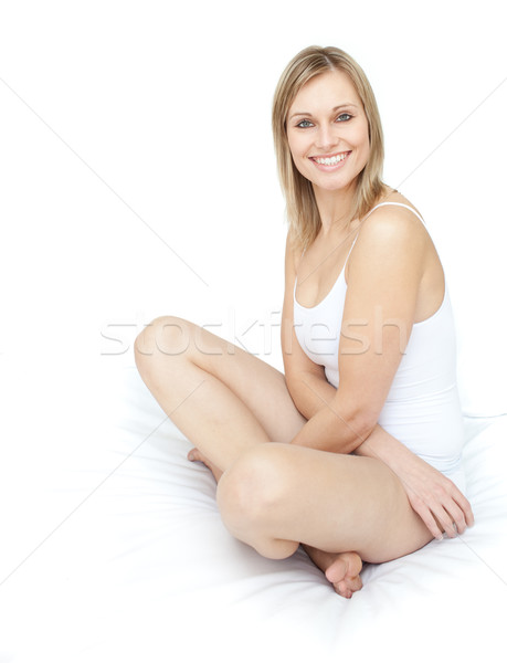 Delighted smiling woman sitting on a bed Stock photo © wavebreak_media