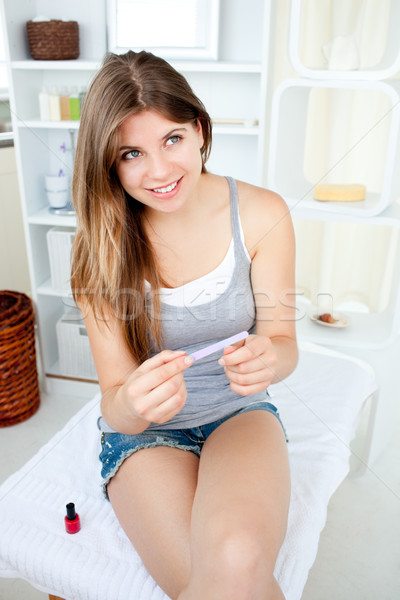 Attractive young woman file her nails in the bathroom at home Stock photo © wavebreak_media